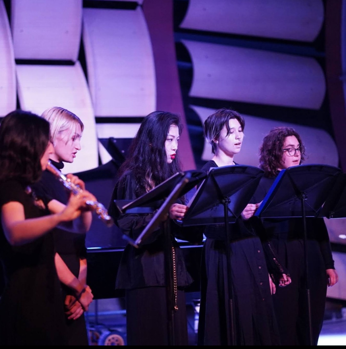 a choir sings with music stands